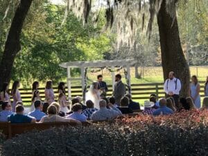 Bride and Groom at the altar surrounded by oak trees.