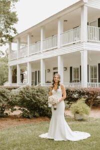 Bride in front of manor house at Jaxweddingvenue